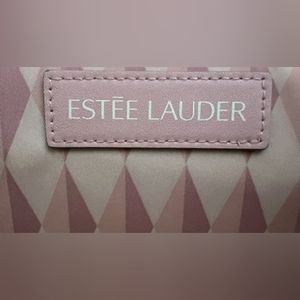 NEW without the tag. ESTEE LAUDER  Cosmetic Makeup bag w/flower pendant.